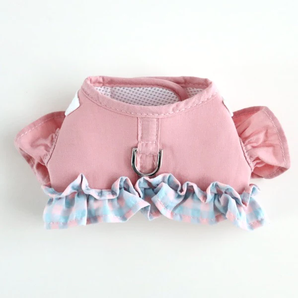 A pink harness with blue and white ruffles on it.