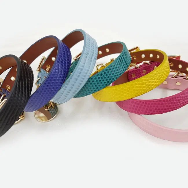 A group of colorful leather bracelets on top of each other.