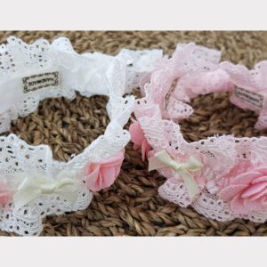 Two bracelets with lace and flowers on them.