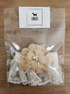 A bag of dog treats with a flower on top.